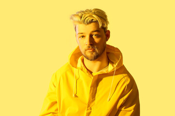 Naklejka premium Toned portrait of handsome young man on color background