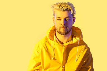 Toned portrait of handsome young man on color background