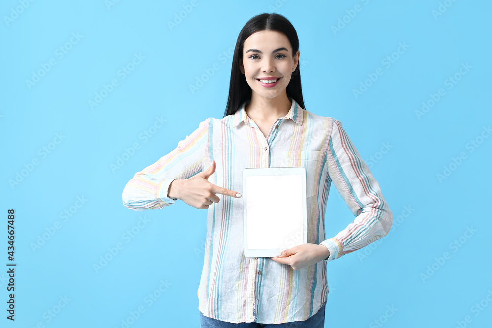 Poster beautiful young woman with tablet computer on color background