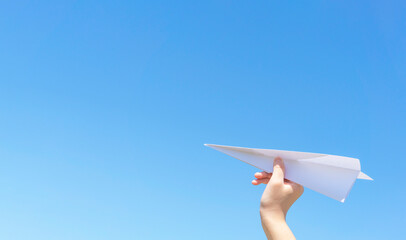 A hand of the child who flies a paper airplane.  紙飛行機を飛ばす子供の手