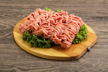 Raw pork minced meat over board