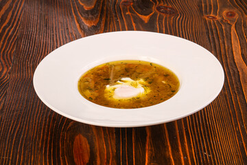 Chicken soup with poached egg