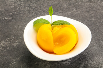 Sweet ripe canned peaches with mint