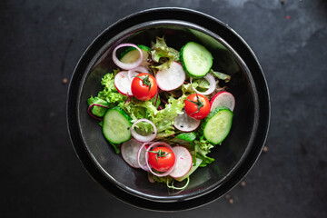 fresh vegetable green salad radish, cucumber, mix leaves veggie meal snack summer menu diet vegan or vegetarian food copy space food background rustic top view