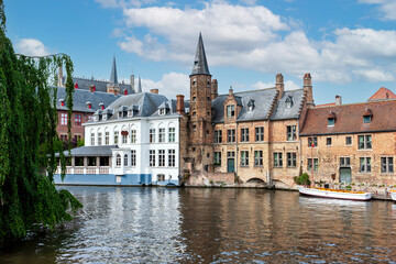 Fototapeta premium City view with historical houses, church, tower and famous canal in Bruges, Belgium.