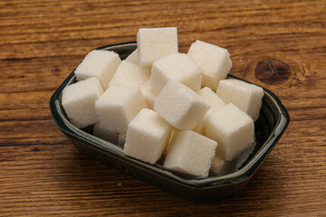 Refined white sugar cubs in the bowl