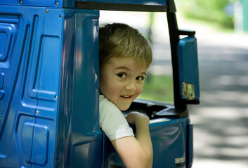 boy rides a car in the park