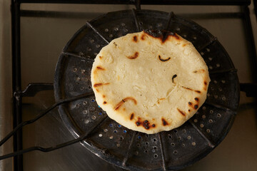 Roasting corn arepas on a grill. Typical food of Colombia