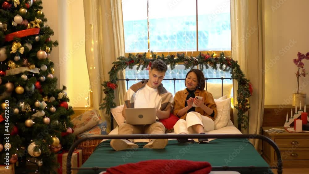 Poster diverse couple in love using cellphone and laptop technology for browsing web pages, man making onli