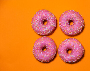 pink donuts on orange background