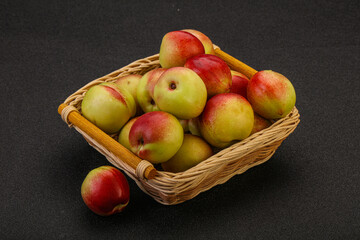 Sweet small nectarines in the basket