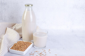 Buckwheat milk in glass bottle and glass.