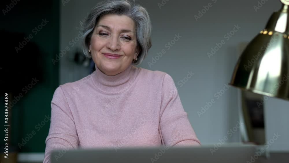 Poster contemplative woman searching website while working remotely on cropped laptop computer sitting at d