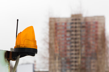 Alarm beacon with antenna for signal transmission. Signal lamp on a metal pole against the...