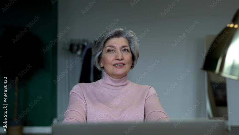 Poster caucasian happy woman making informative notes while working remotely on cropped laptop computer sit