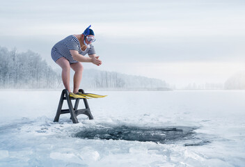 Fuunny overweight, retro swimmer about to jump into ice hole in the lake, with copy space - obrazy, fototapety, plakaty