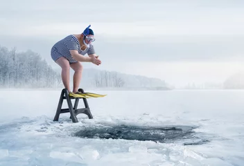 Fuunny overweight, retro swimmer about to jump into ice hole in the lake, with copy space © rangizzz