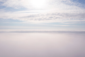 Fototapeta premium Aerial view white clouds in blue sky. Aerial top view cloudscape. Texture of clouds. View from above. Clouds texture background. Panorama clouds texture