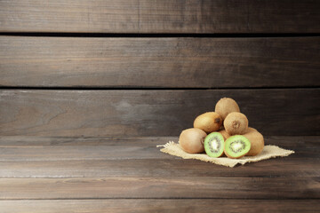 kiwi on a wooden background. a bunch of ripe kiwi fruit on a napkin on a wooden background