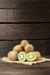 kiwi on a wooden background. a bunch of ripe kiwi fruit on a napkin on a wooden background....