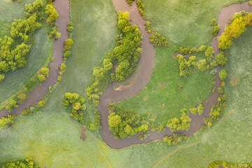 Aerial view of river meander in the lush green vegetation of the delta
Top view of the valley of a meandering river among green fields and forests.
Romantic background concept