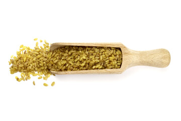 bulgur wheat grain in a wooden scoop isolated on white. Vegan healthy food