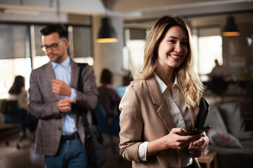 Businesswoman in office. Smiling businesswoman using the phone.