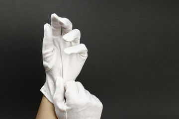 Woman puts on White cotton gloves to moisturize the skin - obrazy, fototapety, plakaty