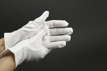 Woman puts on White cotton gloves to moisturize the skin