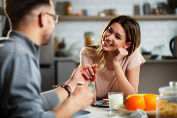 Beautiful young woman enjoying in breakfast with her husband. Husband and wife enjoying in the morning.
