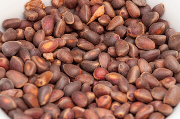 A pile of roasted coffee beans, rough brown in color