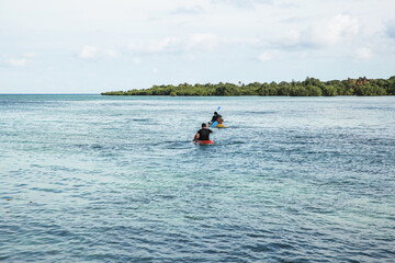 Fototapeta na wymiar People kayaking in the ocean near the island at Karimun Jawa