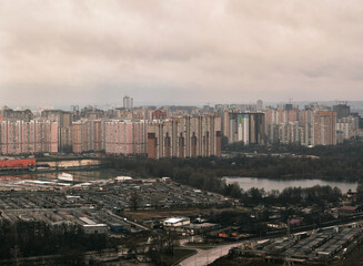 Fototapeta premium Rooftop view of Kyiv Ukraine. Dramatic sky after the rain. Clouds with silver lining.