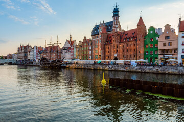 Fototapeta na wymiar Gdansk city riverside view on famous facades of old medieval houses on the promenade in Gdansk city