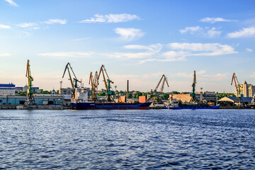 Cargo ships and harbor cranes in the Kherson river port - view from the Dnieper river (Ukraine)....