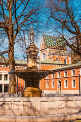 Obraz premium Beautiful stone water well in front of the famous Old Salt Works Bad Reichenhall, Bavaria, Germany on a sunny day in spring