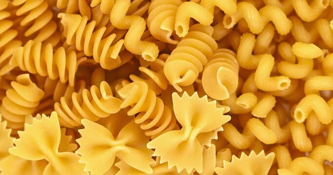 Italian pasta rotate. Variety of types and shapes of dried Italian pasta.Super slow motion