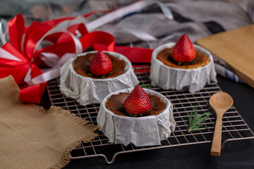 Burnt Cheese Cake, Basque Cheesecake with strawberry topping on Parchment Paper.