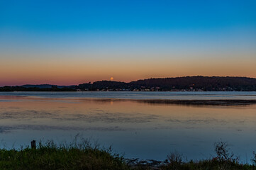 Nearly a full moon, sunset waterscape