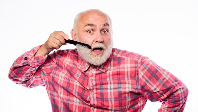 Man bearded barber handsome hairstylist use tool styling beard. Male haircut. Comb hair. Hairstylist use professional equipment. Barbershop concept. Hairdresser service. Hairstylist bold head