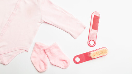 Children's personal care kit. Baby bath set . Newborn baby's clothers for girl - bodusuit and socks, booties. on white background. top view
