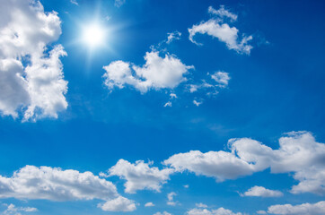 Blue sky with clouds and sun.