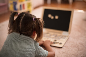 Toddler playing interactive games for good development at home. Close up.