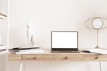 Laptop with blank screen mock-up on wooden table in home scandi interior. Interior still life...