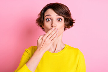 Portrait of attractive funny girlish brown-haired girl closing mouth oops isolated over pink pastel color background