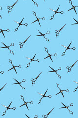 Background of black scissors. professional hairdresser black scissors isolated on blue. Black barber scissors, close up. pop art background, for prints or posters. not seamless pattern