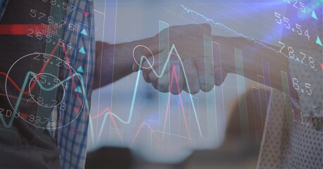 Stock market data processing against mid section of man and woman shaking hands