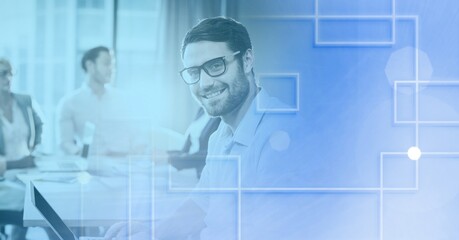 Composition of white shapes over diverse group of businesspeople in modern office