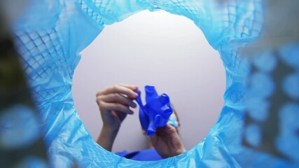 recycling, waste sorting and sustainability concept - doctor or healthcare worker throwing used medical gloves into trash can - Powered by Adobe