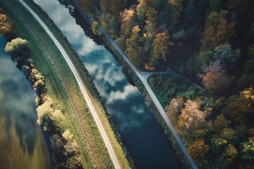 a drone-view of a river and a channel with clouds in the reflection, near Munich, Bavaria, Germany